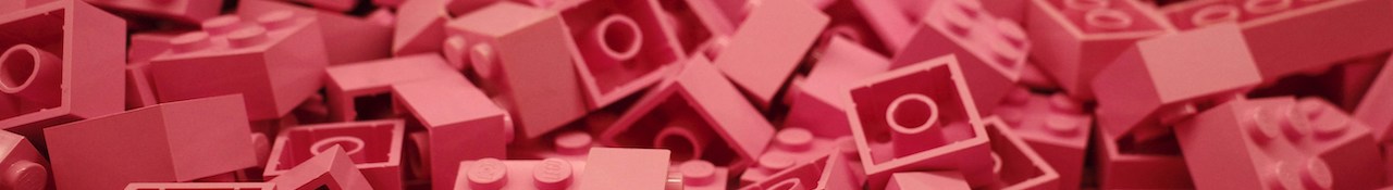Close-up of pink LEGO bricks piled together in a horizontal banner image