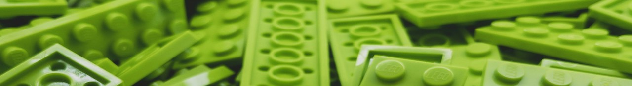 Close-up of green LEGO bricks piled together in a horizontal banner image