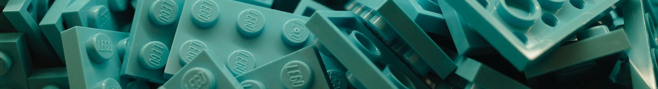 Close-up of teal LEGO bricks piled together in a horizontal banner image